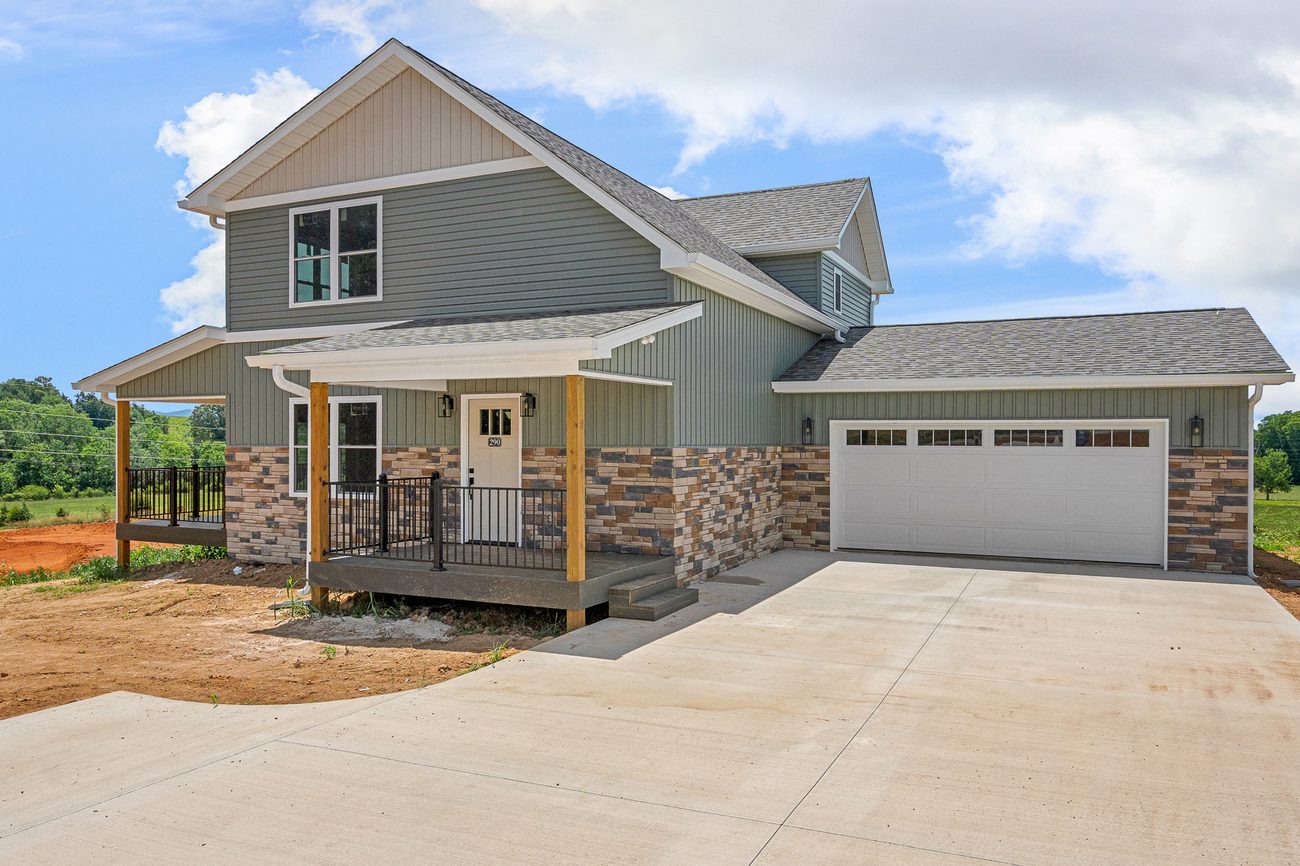Completed two-story craftsman home with timber porch posts by Reliable Building Services