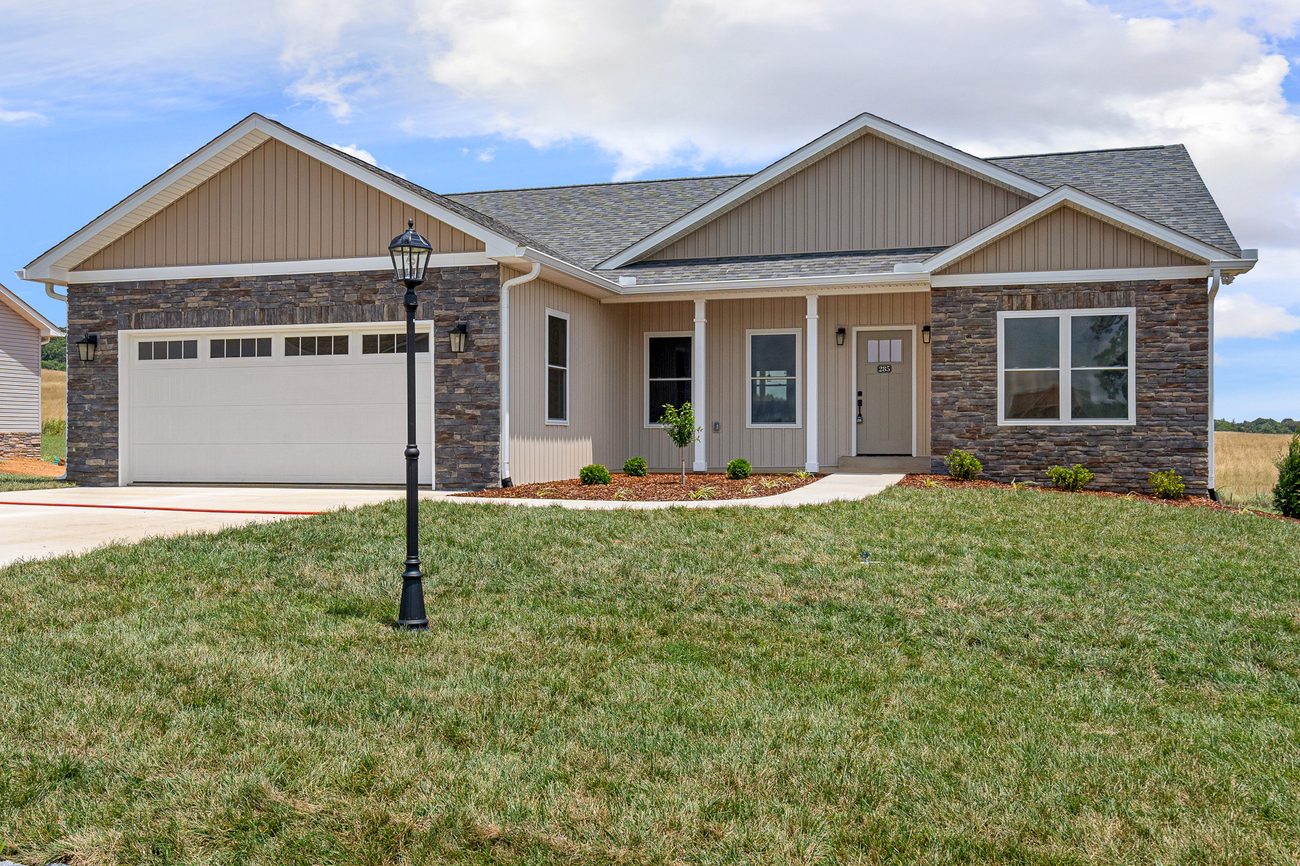 Completed single-level craftsman home with stone and board-and-batten by Reliable Building Services